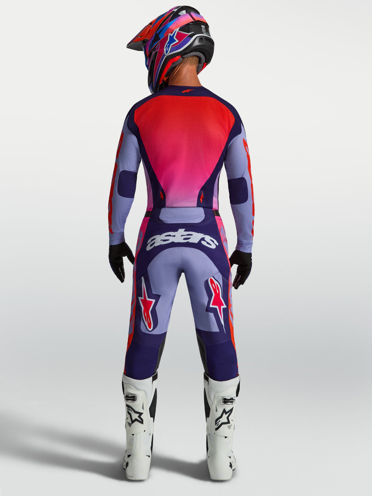 Alpinestars 2027 Racer Air Hunt Gear Set, purple and red ventilated motocross jersey and pants, rear view on rider.