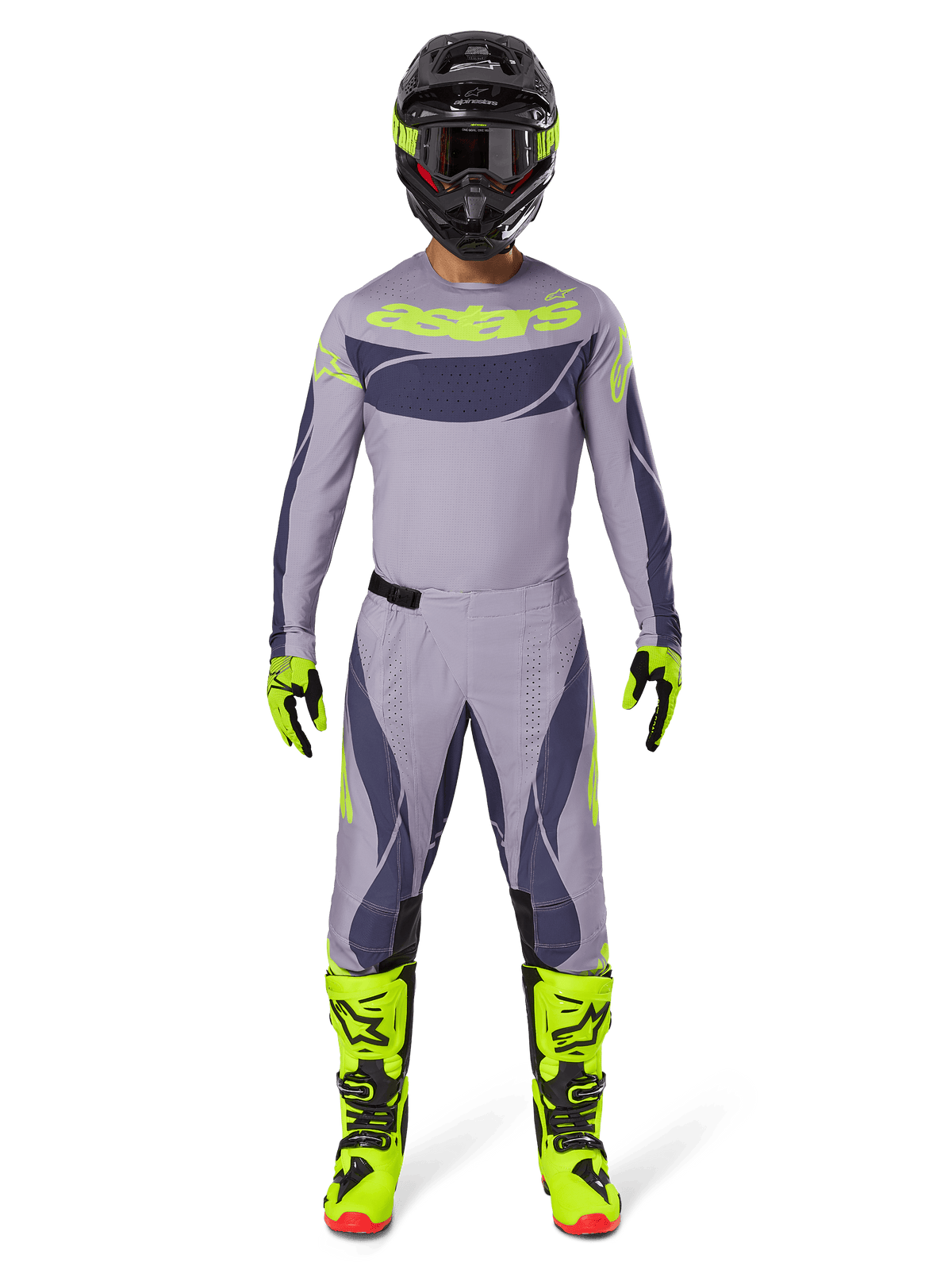 Pilote de motocross portant une tenue de course complète, maillot Techstar Dreem 2025 gris et gris foncé avec logo jaune fluo, pantalon assorti gris et gris foncé, bottes jaune fluo et noires, casque noir avec accents fluo, tenue coordonnée pour motocross professionnel