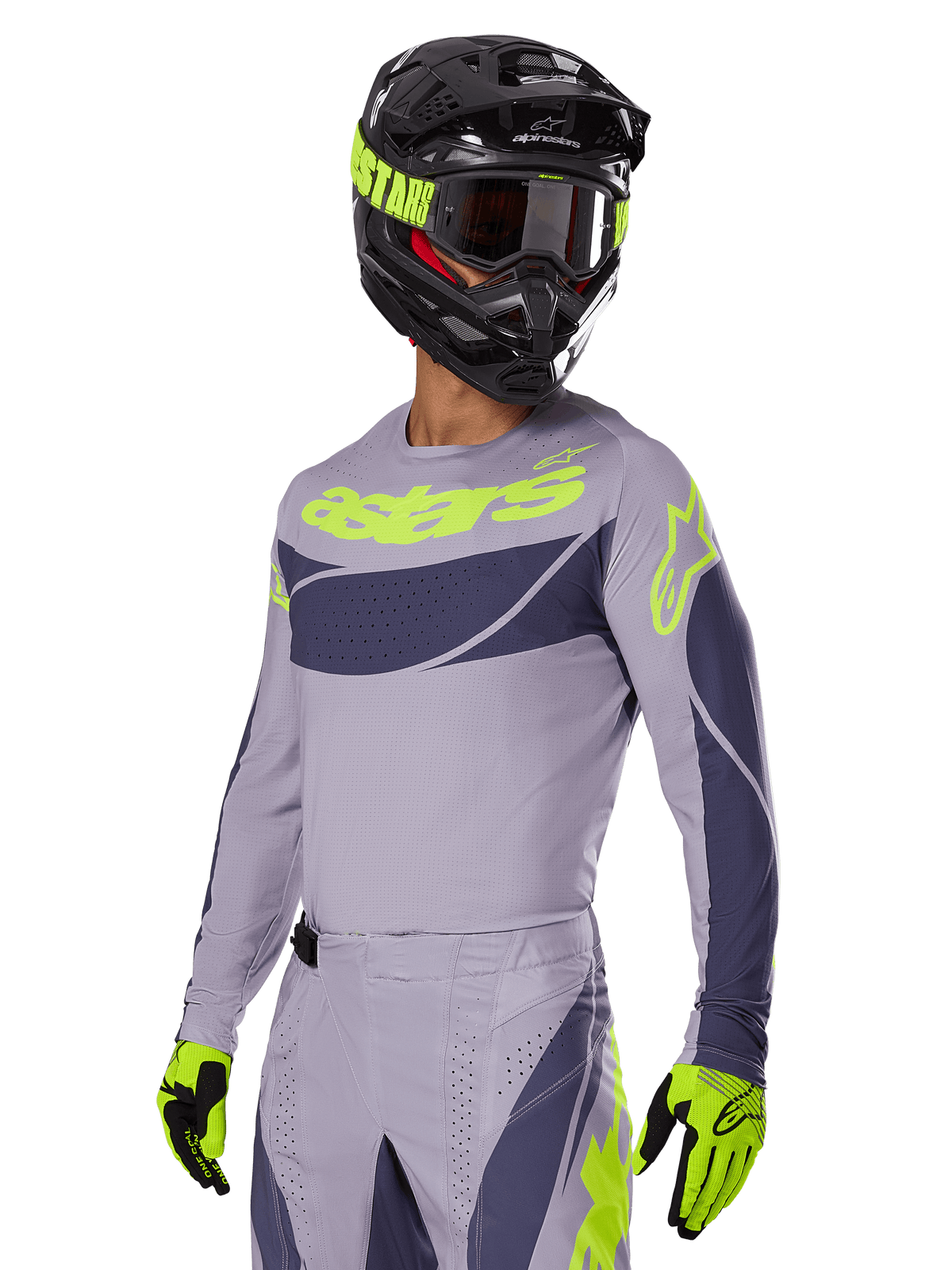 Motocross rider wearing Alpinestars 2025 Techstar Dreem Jersey, Gray and Dark Gray with lime green logos, matching pants, black helmet with lime green accents, lime green and black gloves, coordinated outfit for off-road racing
