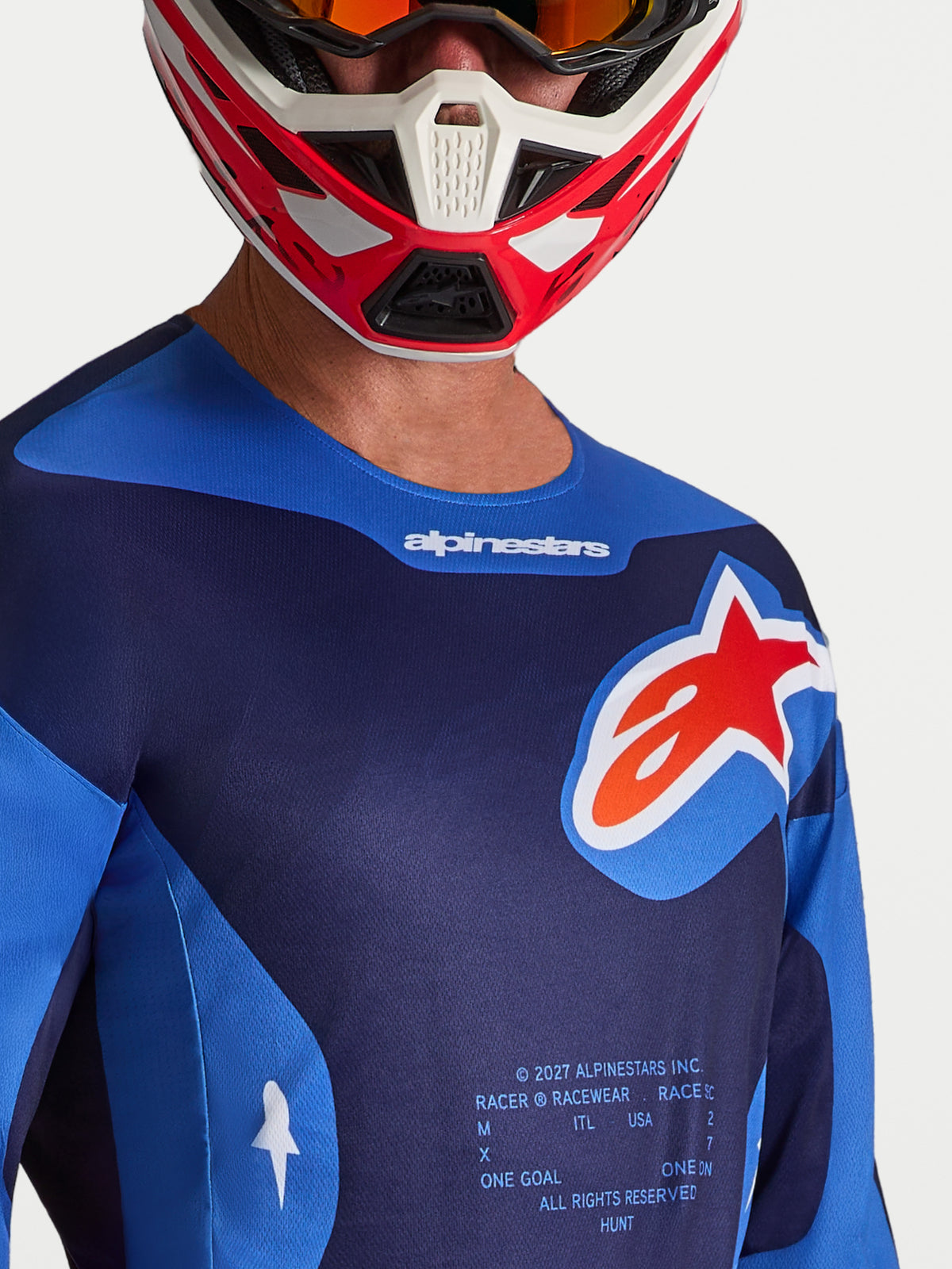 Maillot Racer Hunt Alpinestars pour homme, maillot de motocross bleu et rouge, logo Astars, porté par un pilote.