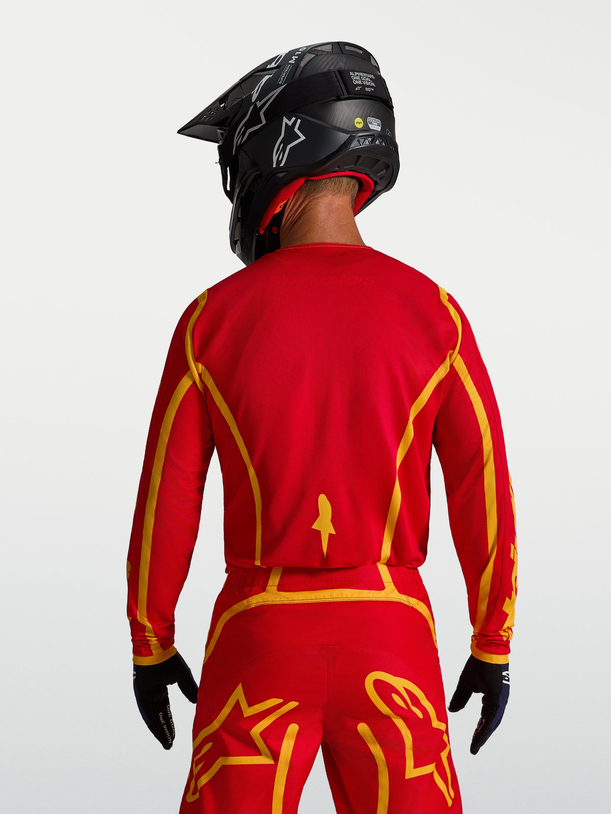 Maillot Alpinestars Fluid Apex V2, tenue motocross homme, rouge et doré, vue de dos, coupe ergonomique et tissu respirant