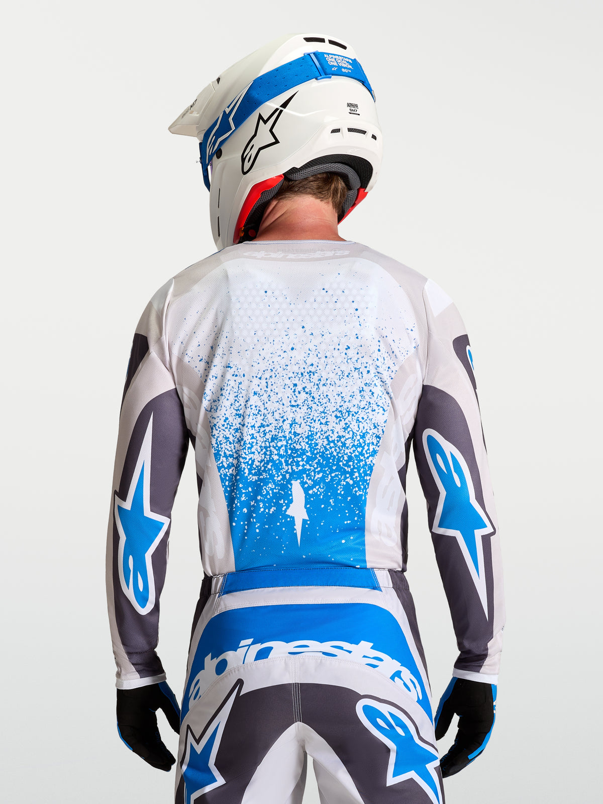 Alpinestars Maillot Fluid Drag, maillot de motocross pour homme, gris et bleu, respirant, vue de dos montrant la coupe allongée