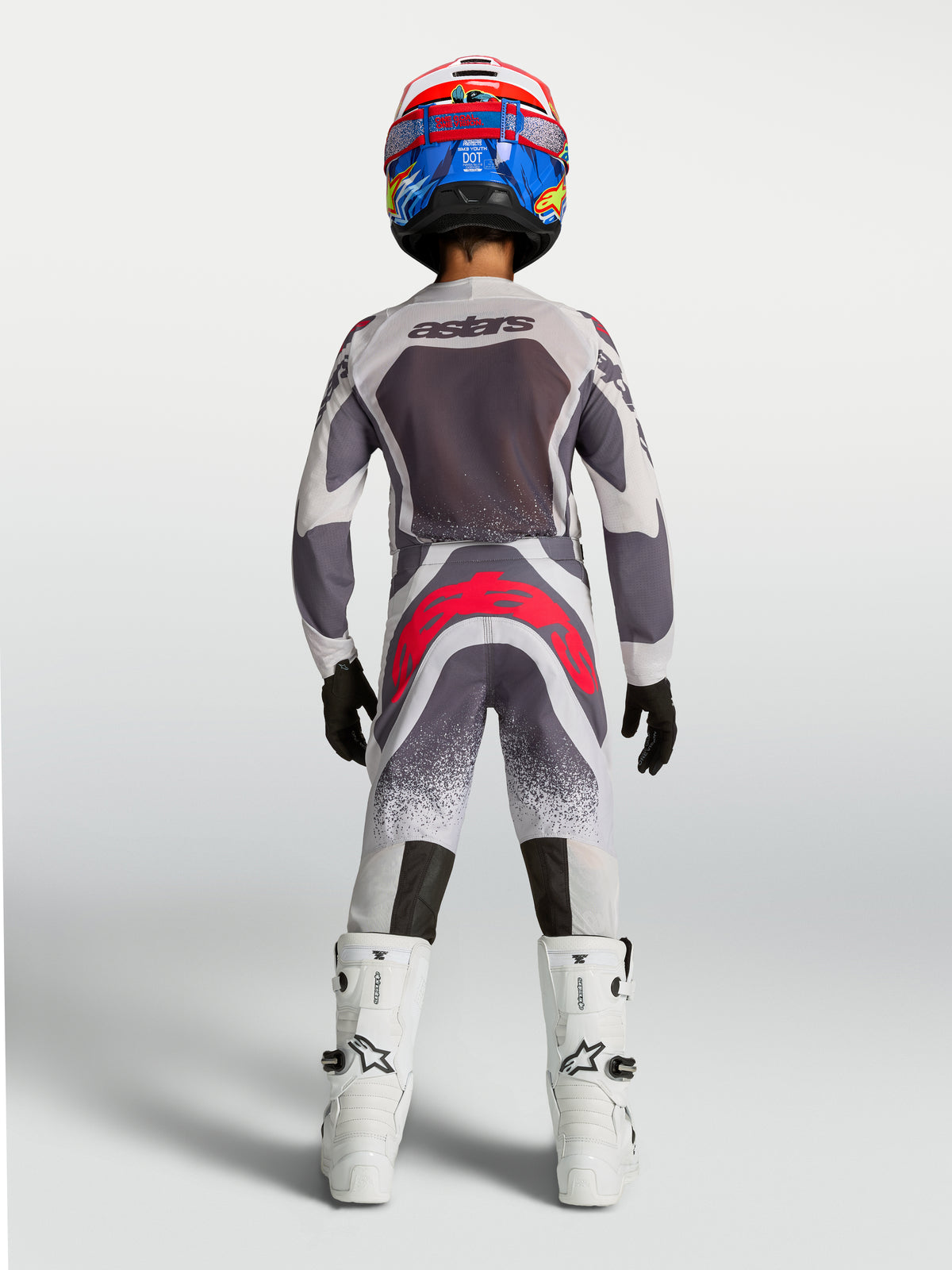 Alpinestars 2027 Youth Supertech Swan Jersey and Gear Set, gray and white motocross gear with red accents, rear view.