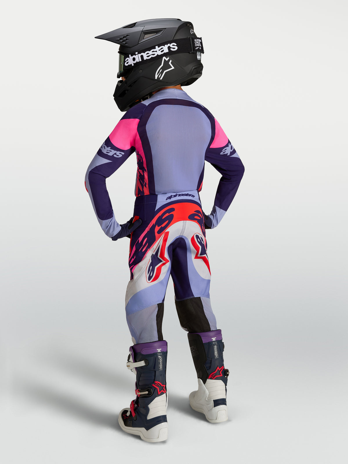 Alpinestars Youth Supertech Dyna Gear Set, purple and pink motocross outfit with jersey, pants, boots, and helmet.