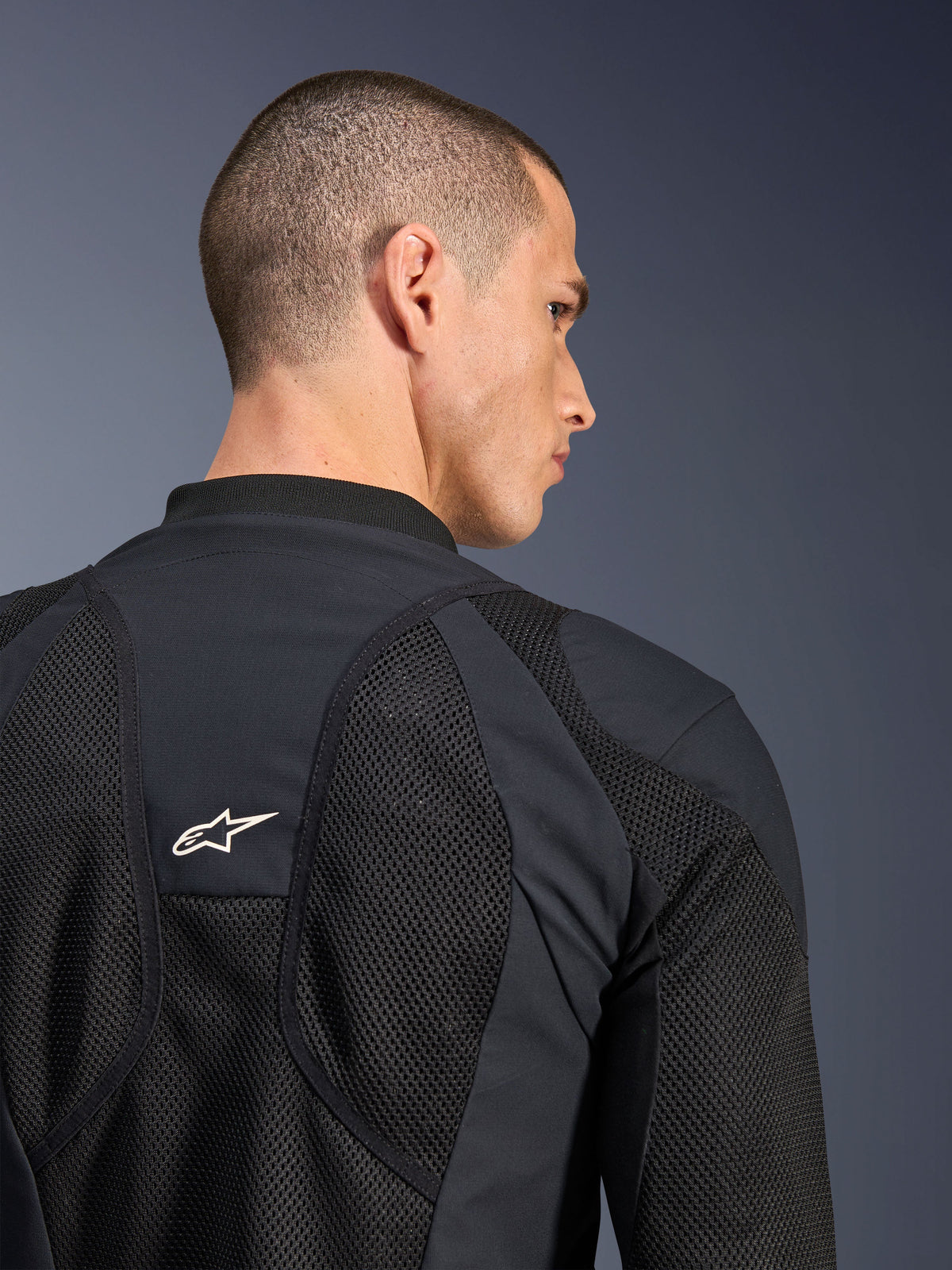 Alpinestars Troop-Air Pro Jacket, Black, close-up view of the back featuring breathable tech mesh panels and a white star logo, premium armored air jacket for motorcycle riding