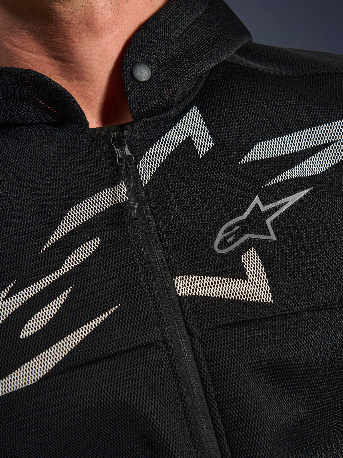 Alpinestars Chrome Superairflow Hoodie, sweat à capuche de moto, noir avec graphismes blancs et gris, gros plan sur le torse montrant la construction technique en maille 3D, fermeture éclair frontale et col à bouton-pression, arborant le logo Alpinestars