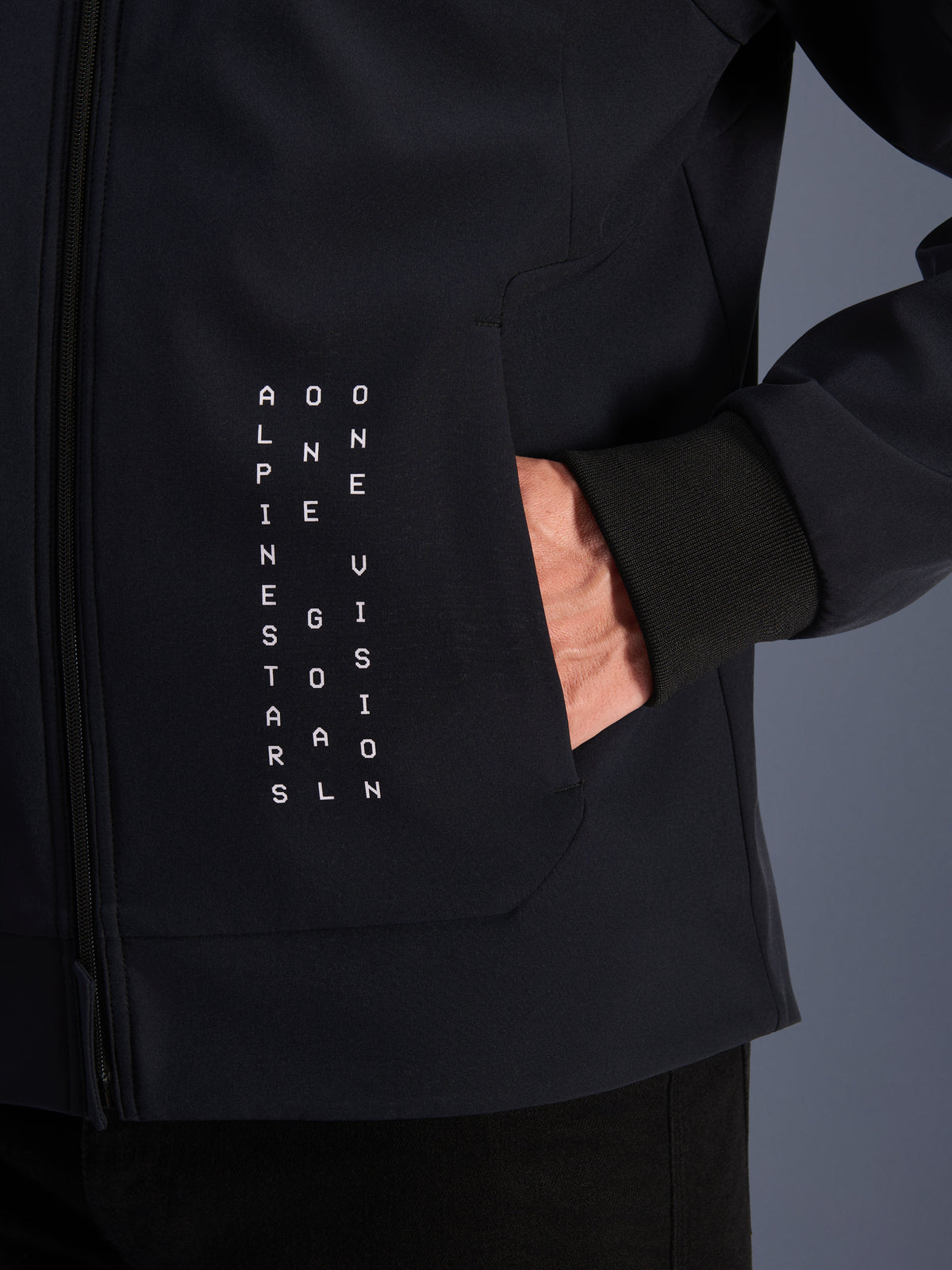 Alpinestars Radium Tech Hoodie, men's urban motorcycle jacket, black with white vertical text and ribbed windproof cuff.