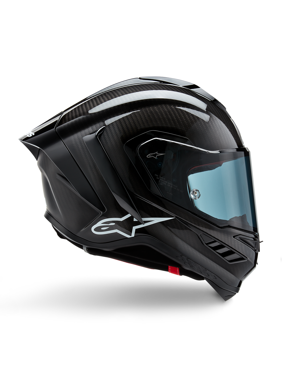 Alpinestars Supertech R10 Solid, casque de moto de course, carbone noir mat et brillant, construction en fibre de carbone, profil latéral, visière teintée bleue, design aérodynamique avec ailerons, logo blanc, protection haute performance de niveau MotoGP