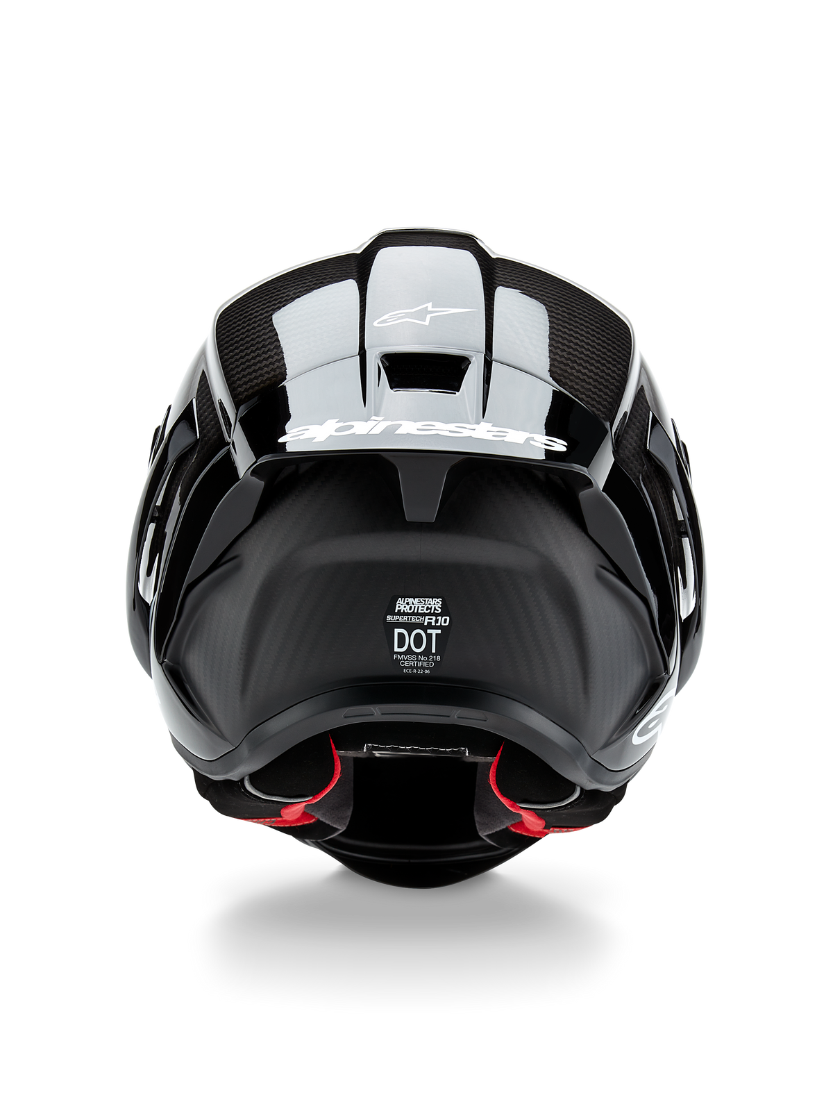 Casque Alpinestars Supertech R10 Solid, casque de moto, noir carbone mat et brillant, vue arrière avec texture en fibre de carbone, spoiler aérodynamique avec logo Alpinestars blanc, étiquettes de certification de sécurité DOT et ECE, et rembourrage intérieur rouge