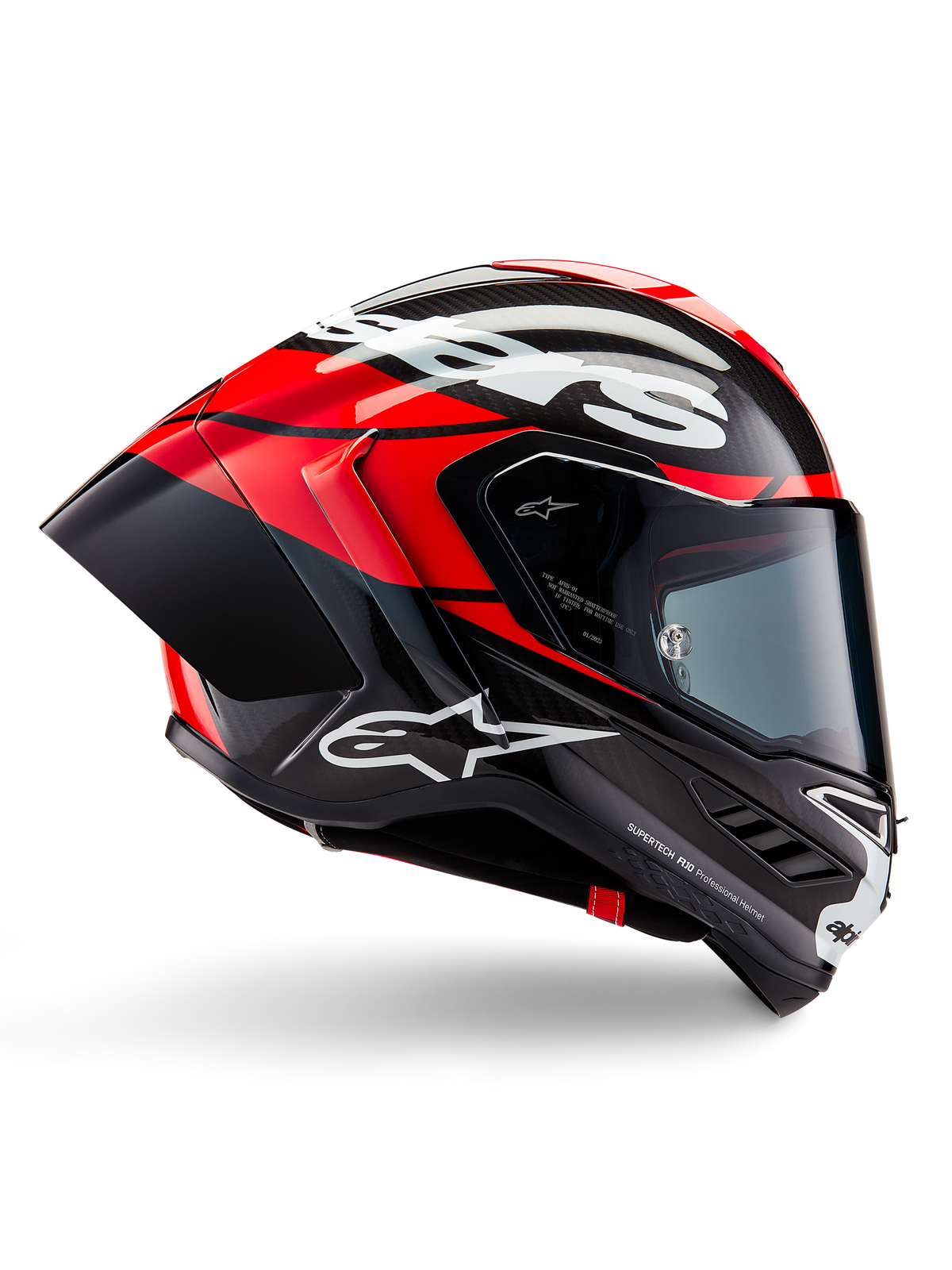 Casque Alpinestars Supertech R10 Element, casque de moto intégral de course, carbone noir avec accents rouge vif et blancs, profil latéral montrant la coque aérodynamique en fibre de carbone, finition brillante avec logo blanc, visière teintée, protection de course professionnelle
