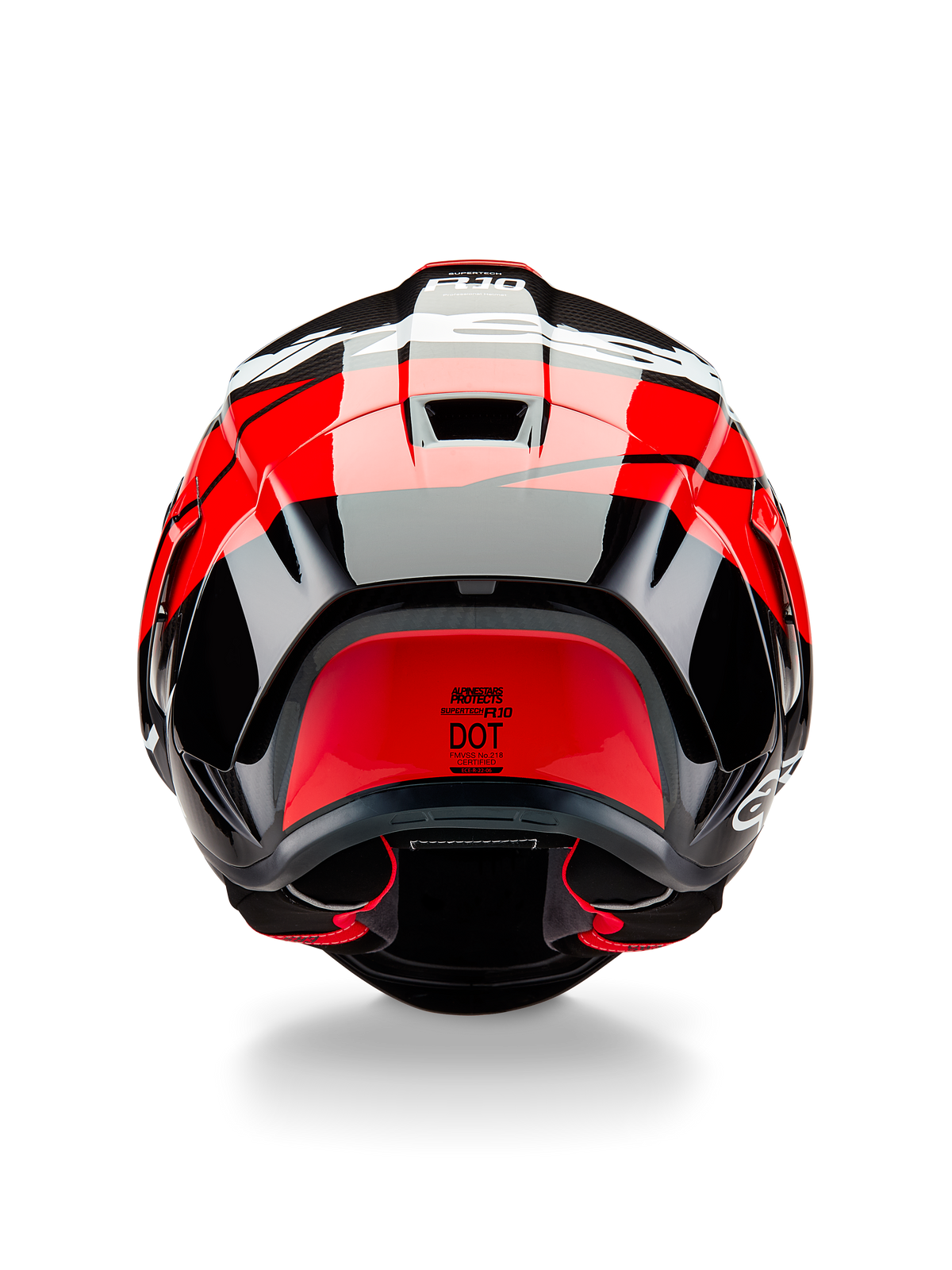 Casque Alpinestars Supertech R10 Element, vue arrière, carbone noir avec des accents rouge vif et blanc brillant, doté d'un aileron arrière aérodynamique, d'extracteurs d'air et de l'étiquette de certification DOT, design épuré inspiré de la course avec détails en fibre de carbone