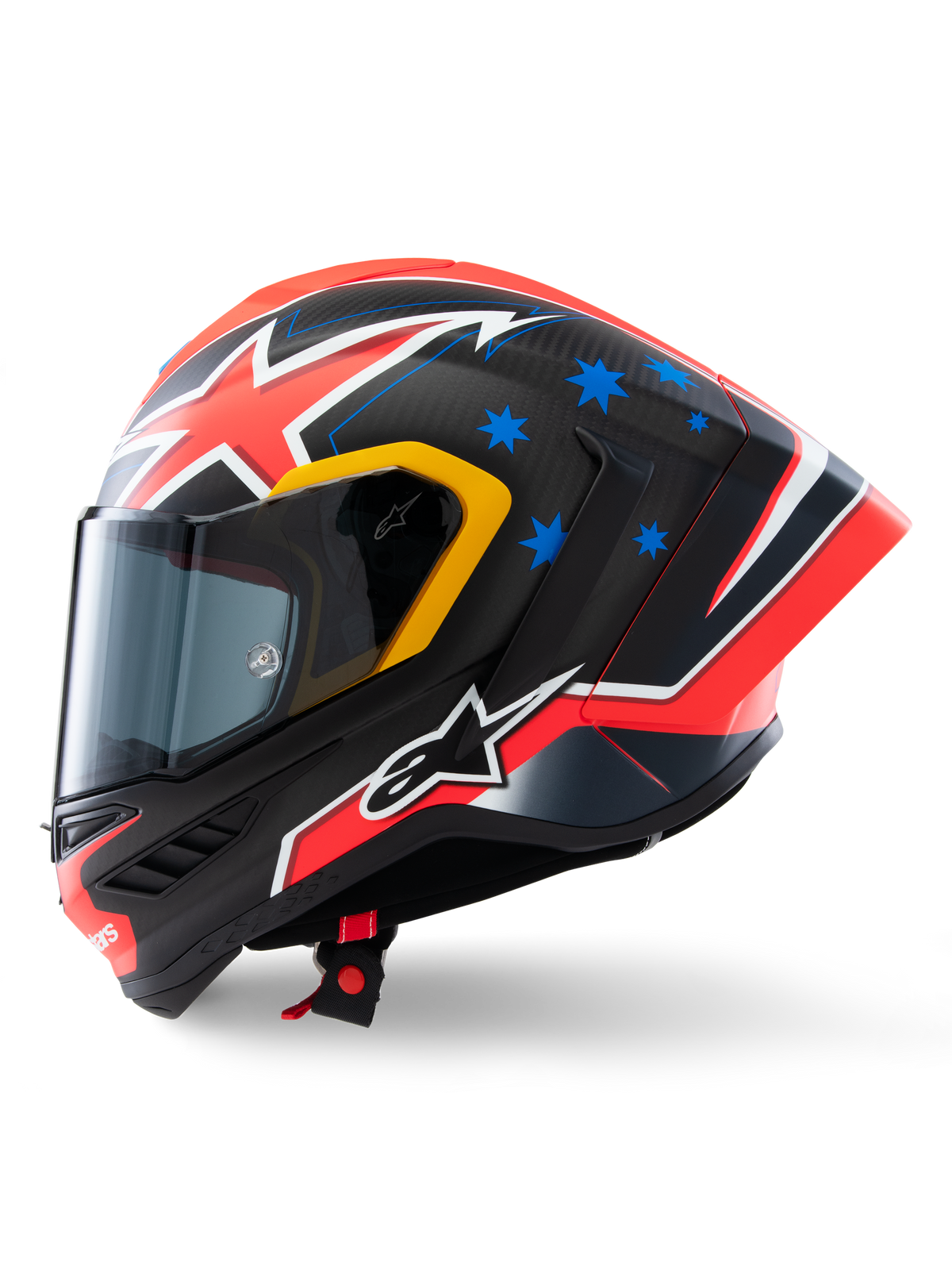 Casque Alpinestars Supertech R10 Miller Édition Limitée, profil latéral, finition Carbon Red Matt avec tissage de fibre de carbone visible, motifs d'éclairs rouges et blancs, étoiles bleues à l'arrière, détails jaunes autour de la visière et logo Alpinestars blanc, casque de moto de course haute performance