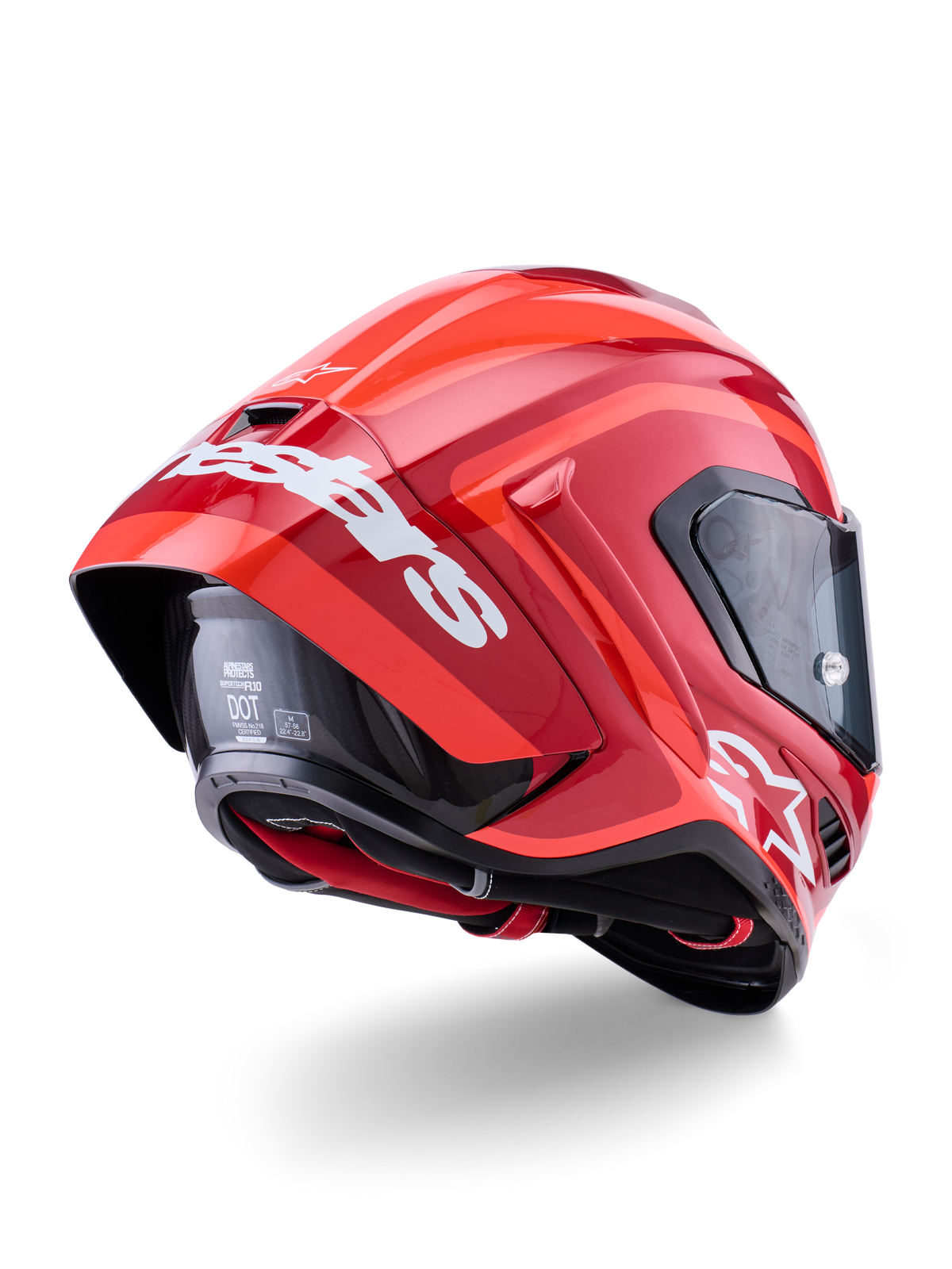 Casque Alpinestars Supertech R10 Arius, rouge brillant avec marquage blanc, vue de trois-quarts arrière montrant le spoiler aérodynamique, construction de la calotte en fibre de carbone et profil de course épuré avec visière foncée