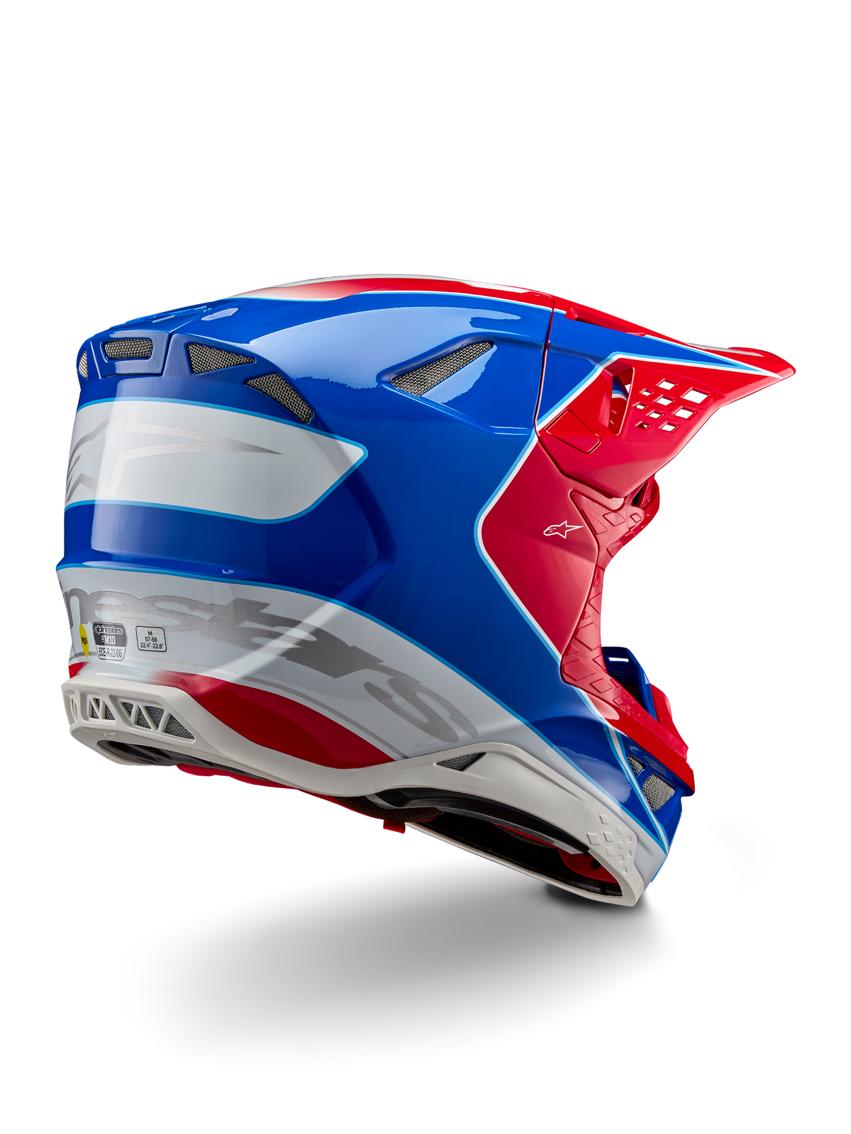 Casque Alpinestars Supertech M10 Aeon ECE 22.06, casque de motocross, rouge vif, bleu et blanc brillant, vue latérale arrière présentant un profil aérodynamique, marquage Alpinestars argenté et orifices de ventilation intégrés.