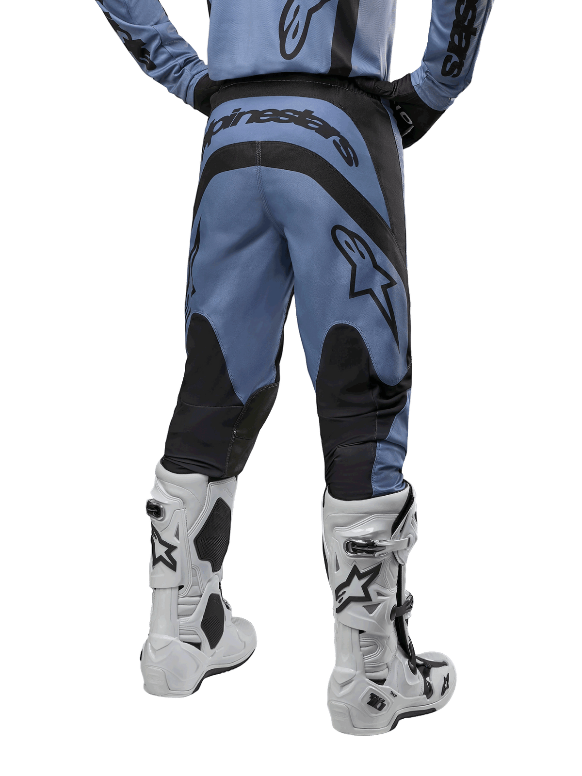 Alpinestars 2024 Fluid Lurv Pants, Motocross Pants, Light Blue and Black, back view showing black reinforced panels and large brand logo, paired with white and black motocross boots, professional racing gear for off-road riding