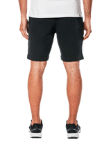 Alpinestars Dunker Short, short d'entraînement en polaire noir pour homme, vue arrière, design décontracté avec taille élastique, porté avec des baskets noires