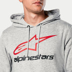 Sweat à capuche Alpinestars Always V3, gris chiné, gros plan sur la poitrine avec logo étoile rouge et lettrage Alpinestars noir, capuche doublée en jersey avec cordons gris, style sportswear décontracté