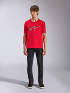 Alpinestars Ageless Shadow CSF Tee, Short Sleeve T-Shirt, Red, Front Ageless logo with white and black outlines, worn by a model with black pants and sneakers, Casual Motorsport Streetwear