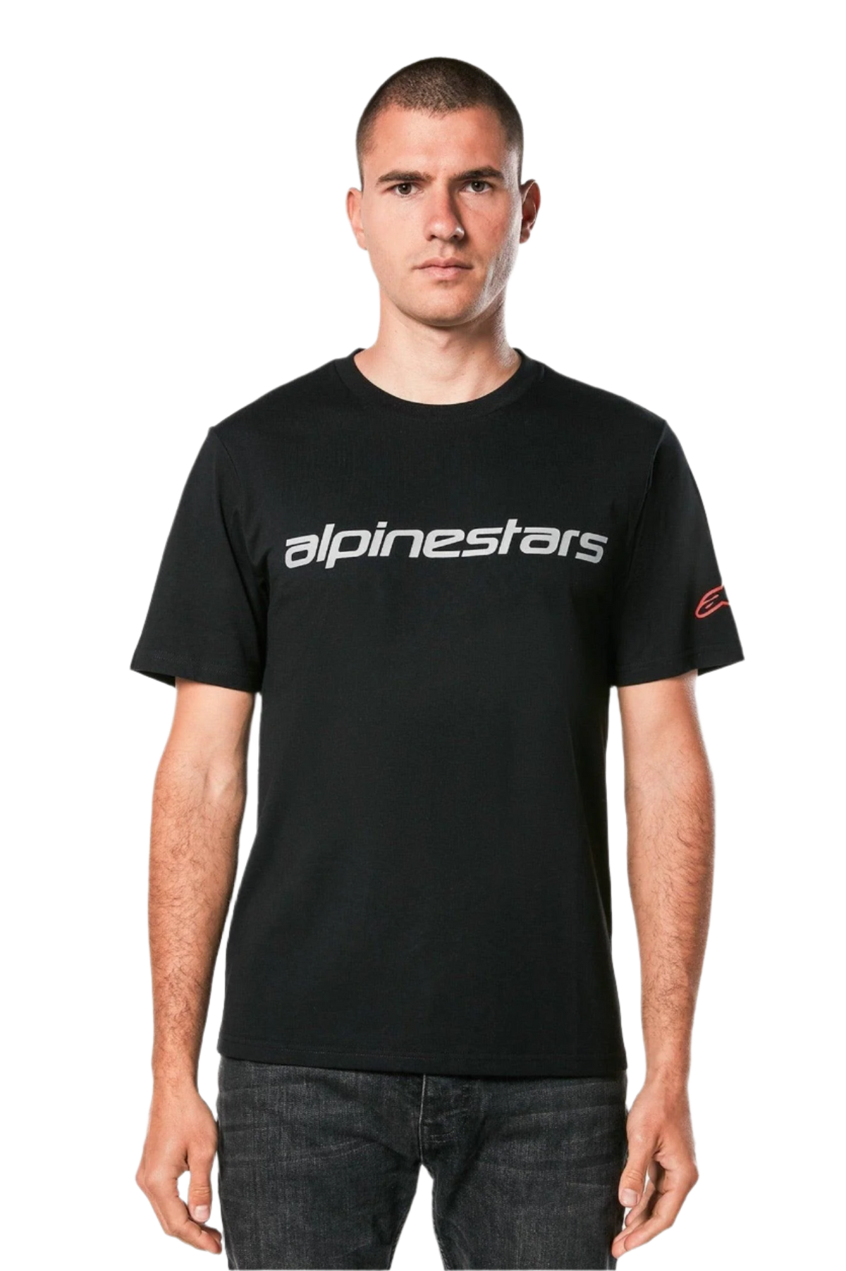Alpinestars Linear Wordmark 2.0 CSF Tee, Short Sleeve T-Shirt, Black, Grey linear wordmark across the chest and red Ageless logo on the sleeve, worn by a model with dark jeans, casual motorsport-inspired streetwear