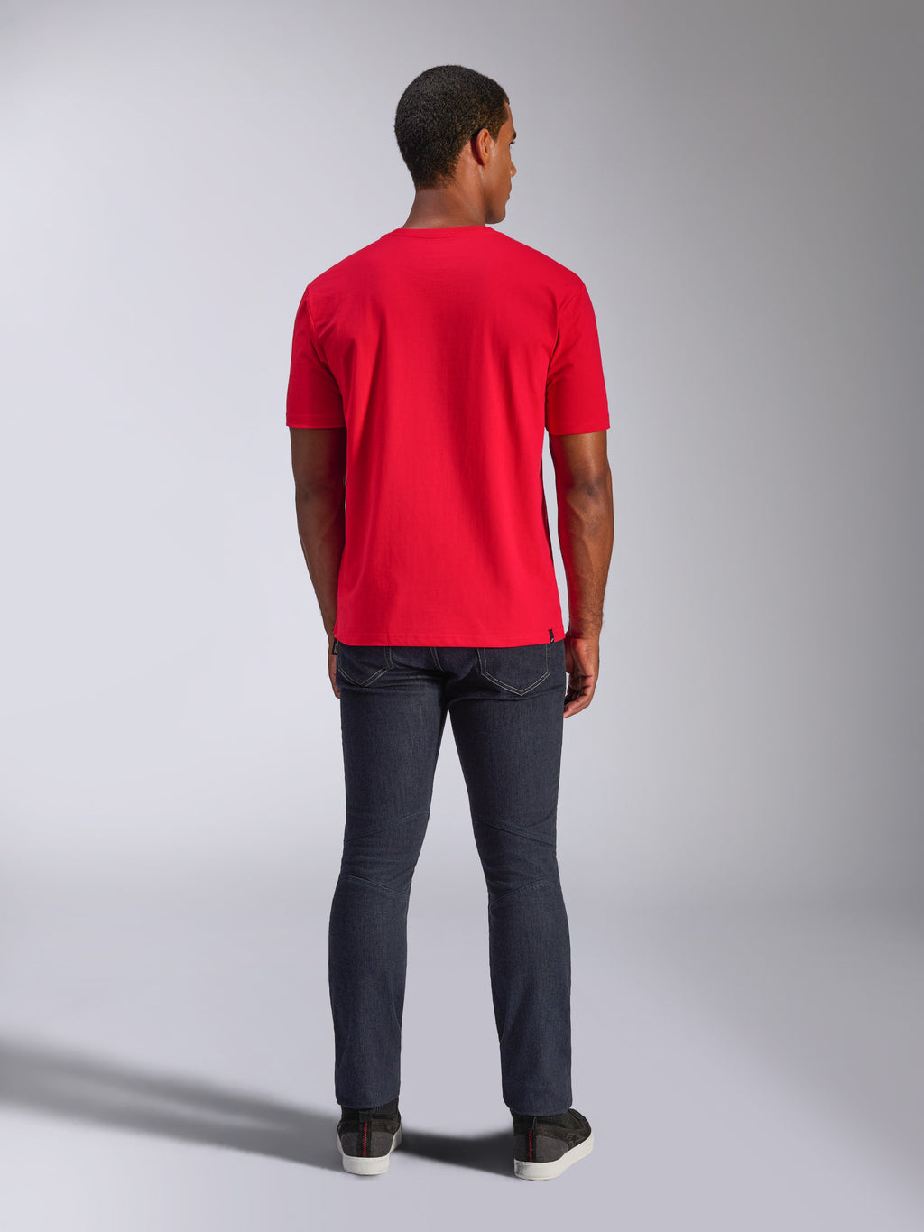 Alpinestars CSF Tee, Short Sleeve T-Shirt, Red, back view on model, paired with dark denim jeans, casual motorsport-inspired streetwear