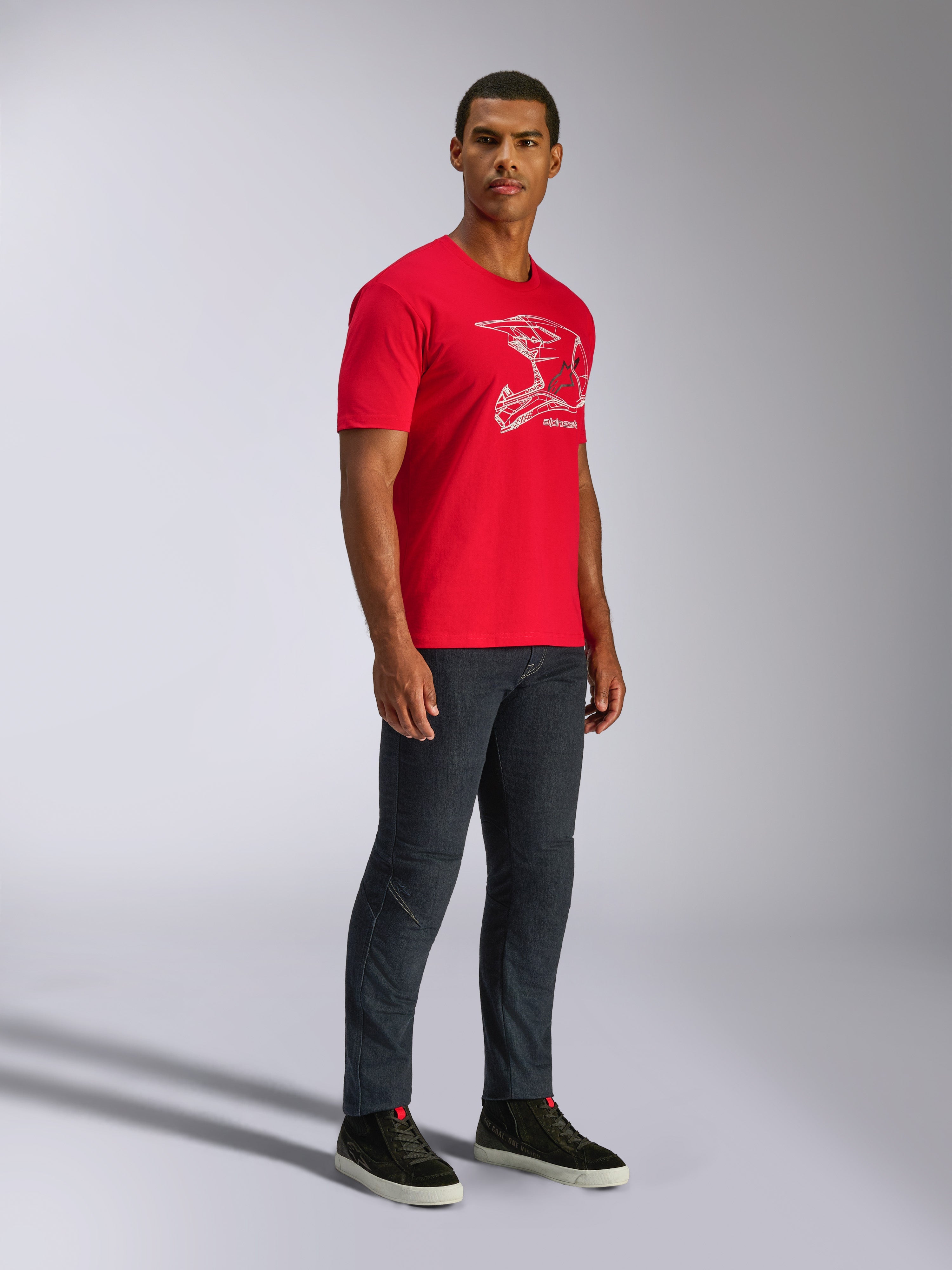 Alpinestars CSF Tee, Short Sleeve T-Shirt, Red, White MX Helmet Graphic, worn by model with dark denim jeans and black sneakers, Casual Motorsport Streetwear