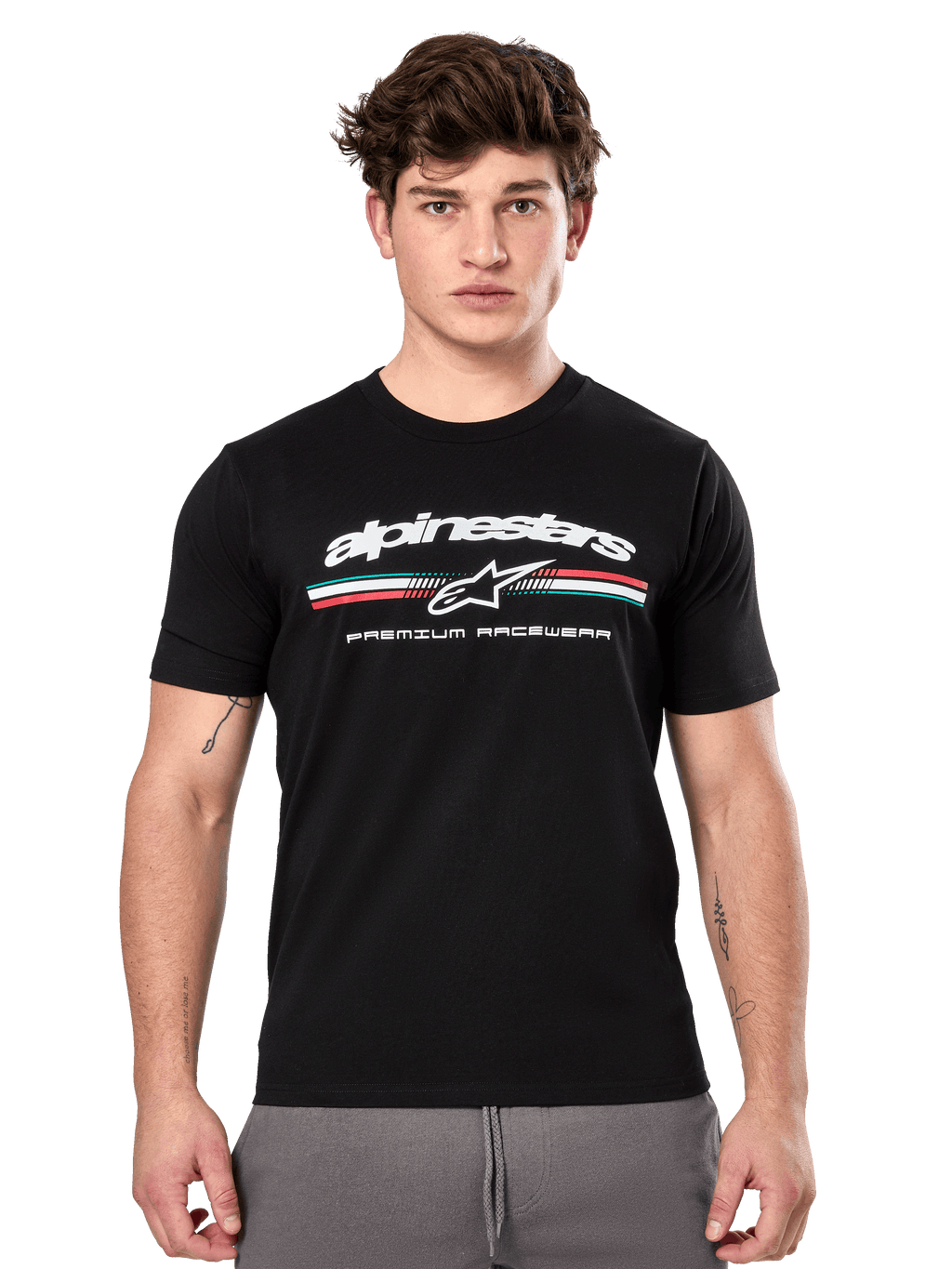 Alpinestars Prevail CSF Tee, t-shirt noir à manches courtes porté par un mannequin, avec logo blanc, bande tricolore et graphisme « PREMIUM RACEWEAR », streetwear décontracté inspiré du sport automobile