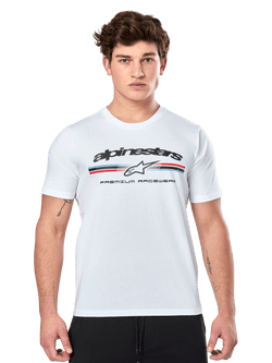 Alpinestars Prevail CSF Tee, White Short Sleeve T-Shirt, featuring a front paddock-style tri-color stripe logo with red and blue accents, black Alpinestars branding, and 'Premium Racewear' text, worn by a male model, casual motorsport apparel