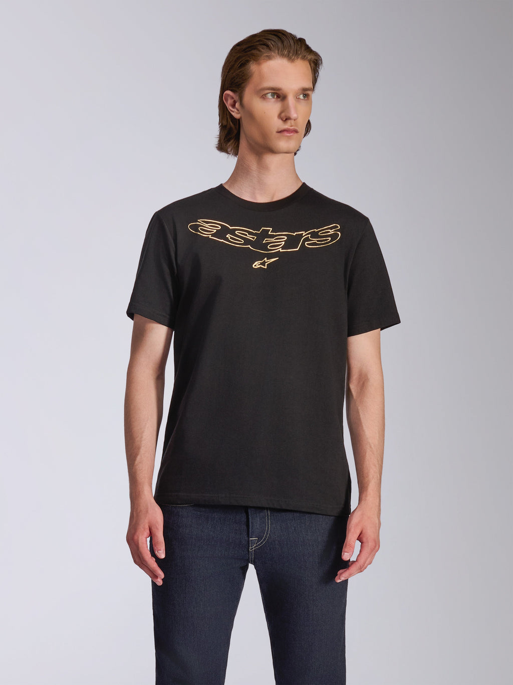Alpinestars Luxo CSF Tee, Short Sleeve T-Shirt, Black, Gold Outlined Astars Logo on Chest, worn with dark blue jeans, Casual Motorsport Streetwear