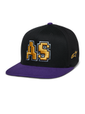 Alpinestars Franchise Hat, casquette à visière plate, noir et violet, logo AS brodé en 3D doré avec contour blanc, visière et bouton supérieur violets, design Flex Fit structuré