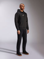 Alpinestars Insight Hoodie, Black, casual pull-over fleece hoodie with white Astars logo on the chest, kangaroo pocket, worn with black pants and sneakers, full-body studio shot, motorsport-inspired streetwear