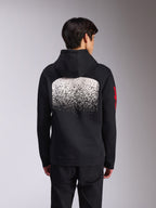 Alpinestars Obsessed Hoodie, vue arrière d'un sweat à capuche noir en polaire, arborant un large graphique blanc moucheté en dégradé MX au dos et des logos Alpinestars rouges sur les manches, style streetwear décontracté inspiré des sports mécaniques