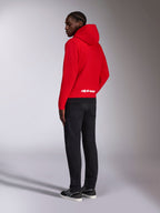 Sweat à capuche Parallel Alpinestars, vue de dos d'un sweat en polaire rouge avec ourlet côtelé noir, logo Alpinestars blanc sur le bas du dos, style streetwear motorsport décontracté