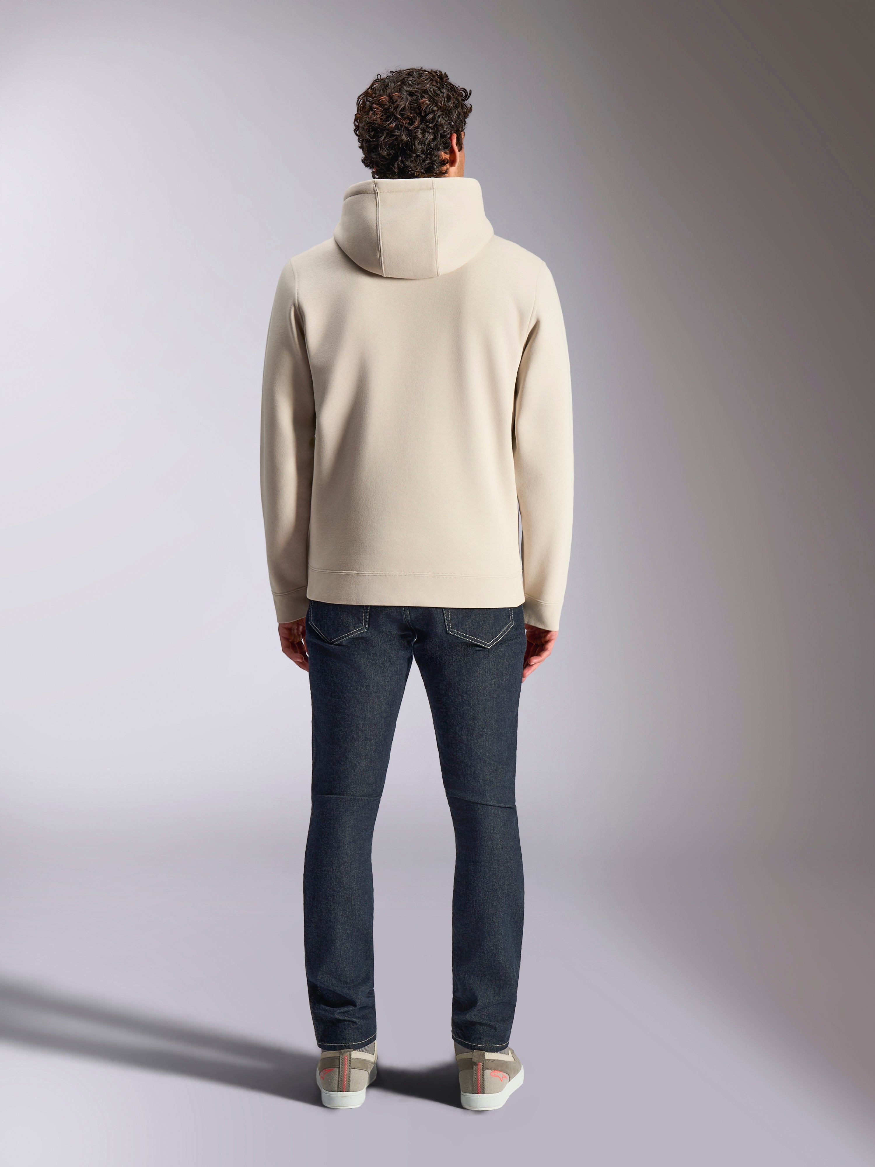Alpinestars Pulse Hoodie, streetwear décontracté, blanc cassé, vue de dos sur un mannequin portant un jean en denim foncé et des baskets, sweat à capuche en polaire avec poignets et ourlet en côtes