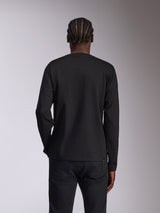 Alpinestars Mandatory CSF Tee, Long Sleeve T-Shirt, Black, back view on model with braided hair, plain black design without graphics, casual motorsport-inspired streetwear