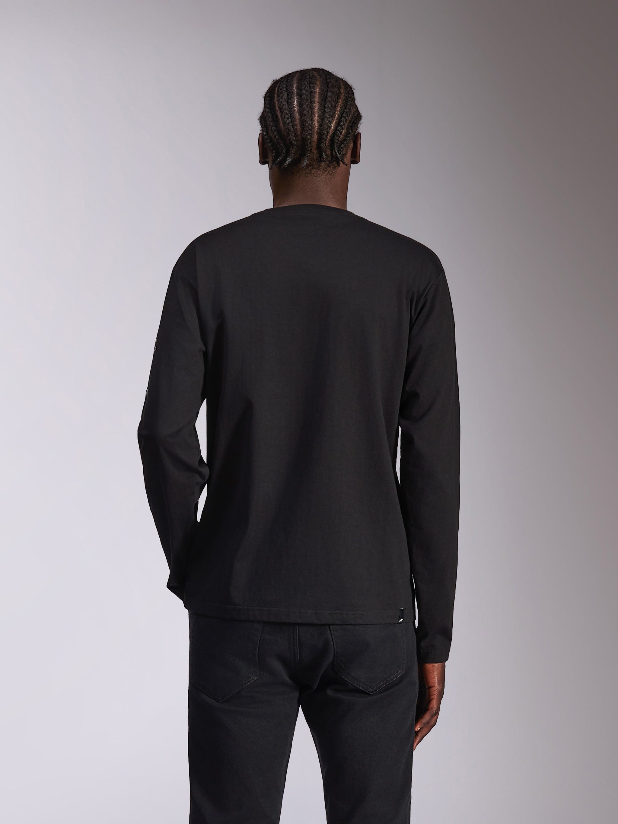 Alpinestars Mandatory CSF Tee, Long Sleeve T-Shirt, Black, back view on model with braided hair, plain black design without graphics, casual motorsport-inspired streetwear