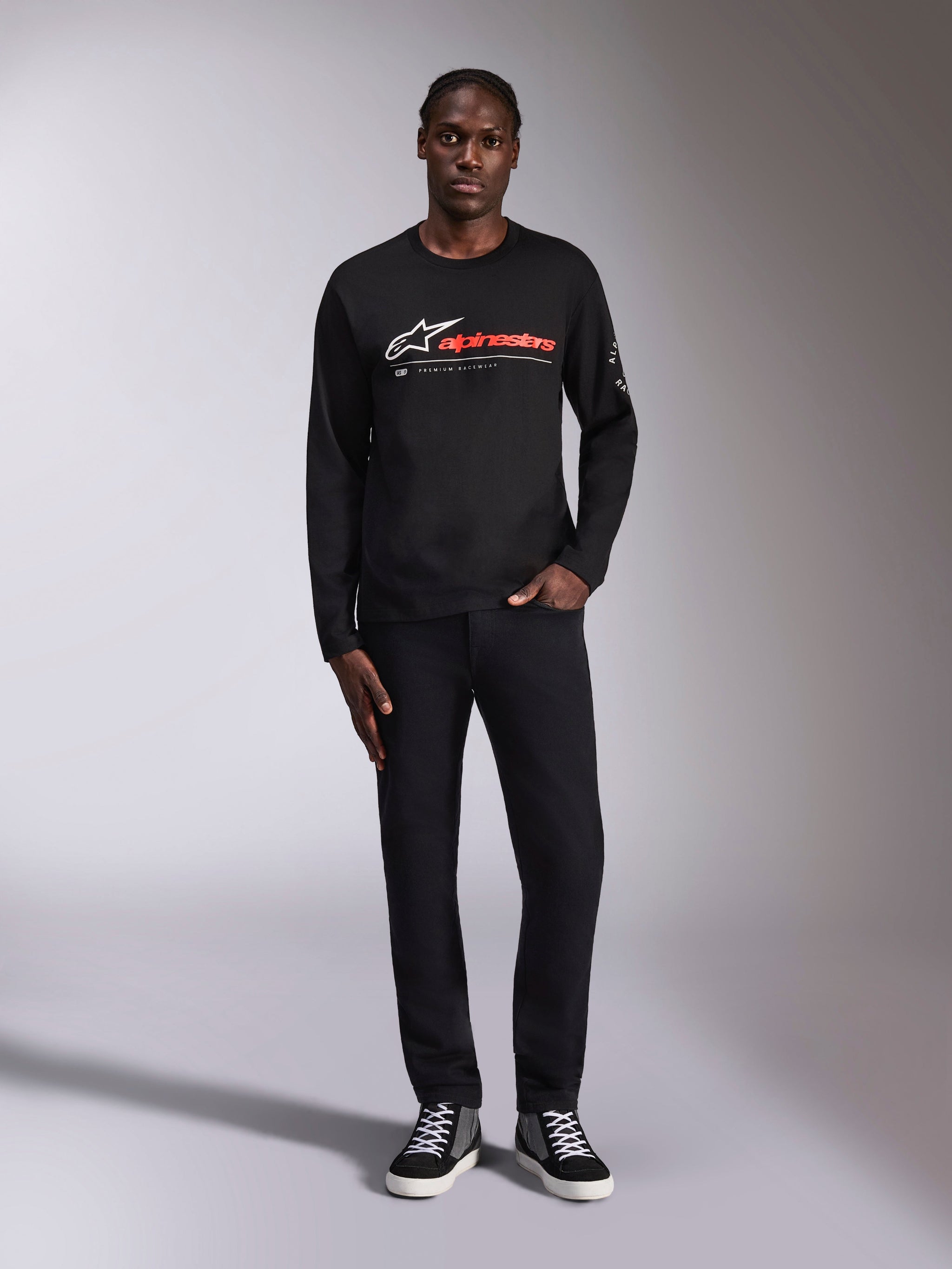 Alpinestars Mandatory CSF Tee, Long Sleeve T-Shirt, Black, White Astars logo and Red Alpinestars wordmark on chest, worn by model with black pants and sneakers, casual motorsport-inspired streetwear