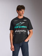 Alpinestars Aplomb Oversized CSF Tee, Short Sleeve T-Shirt, Black, featuring a large teal and white Astars combo logo with checkered graphic, worn by male model with dark blue jeans, casual motorsport streetwear