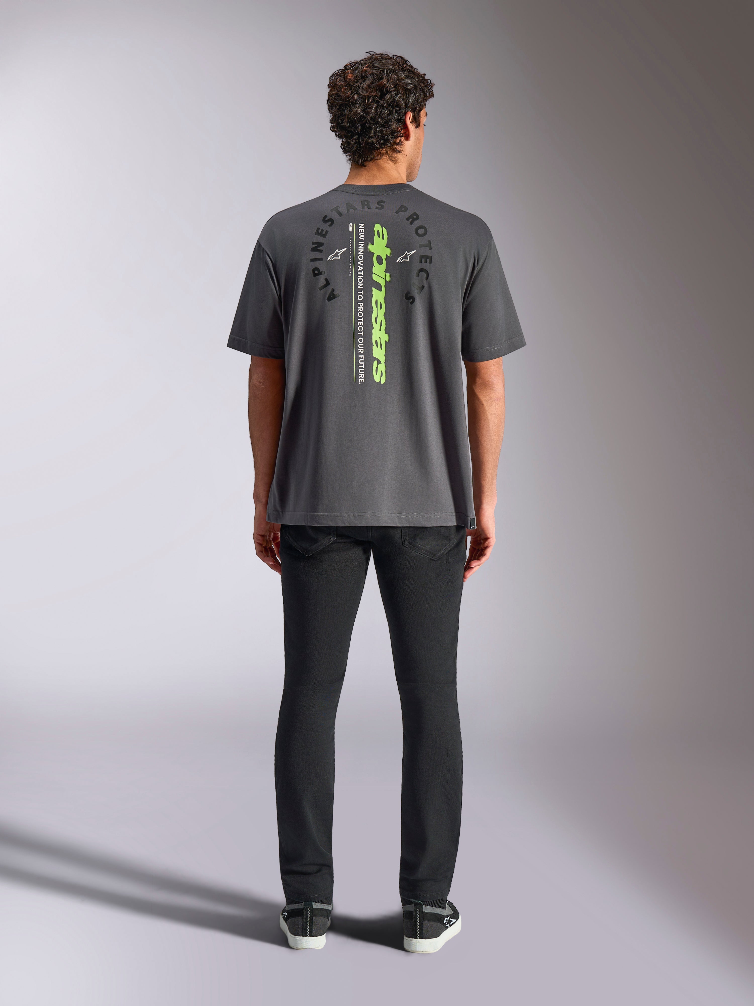 Alpinestars Overhang Oversized CSF Tee, Short Sleeve T-Shirt, Charcoal Gray, rear view featuring vertical neon green Alpinestars logo and graphic text, oversized fit, casual motorsport streetwear