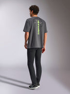 Alpinestars Overhang Oversized CSF Tee, Short Sleeve T-Shirt, Charcoal Gray, featuring a vertical lime green wordmark and circular Alpinestars Protects graphic on the back, casual motorsport streetwear