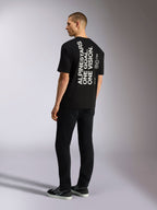 Alpinestars One Oversized CSF Tee, t-shirt à manches courtes, noir, vue de dos avec graphisme blanc vertical « ALPINESTARS ONE GOAL. ONE VISION. », coupe surdimensionnée, streetwear décontracté d'inspiration sport mécanique