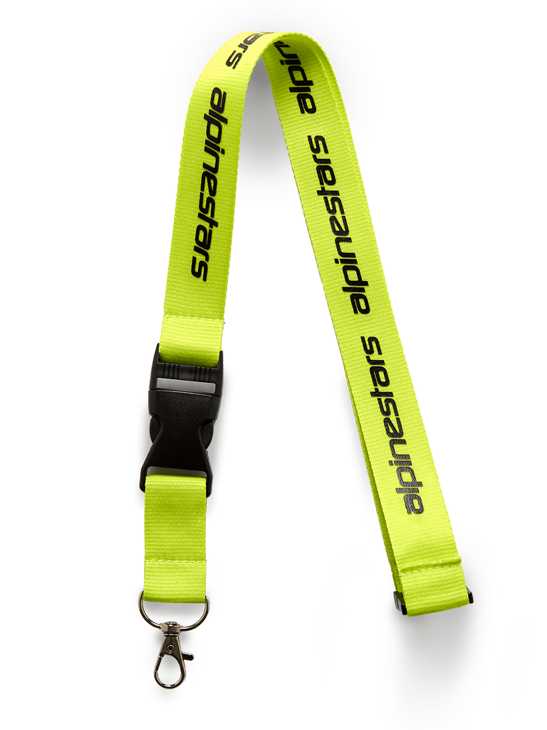 Alpinestars Linear Lanyard, Hi Vis Yellow with black printed logo, features a black breakaway plastic buckle and metal swivel clip, 20-inch polyester neck strap, motorsport-inspired accessory