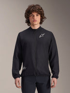 Veste coupe-vent Alpinestars A-Aria, noire, veste de cyclisme légère, avec logo Astars blanc sur la poitrine et marquage en bas à droite, fermeture éclair intégrale, col montant, poignets et ourlet élastiques, coupe performance pour les sports de plein air
