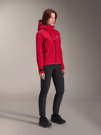Alpinestars Woman Stella A-Dura Elite Waterproof Jacket, Red Fluo, hooded mountain bike rain jacket with white Astars logo on the chest flap, worn with black pants and black mountain bike shoes, technical performance gear for trail riding