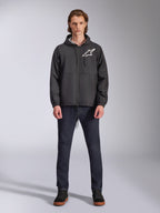 Veste coupe-vent Alpinestars Speeder Chromium, noire avec logo Astars blanc, portée par un mannequin avec un jean bleu foncé et des baskets noires, dotée d'une capuche et d'une fermeture éclair frontale, streetwear décontracté inspiré du sport automobile