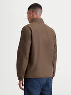 Alpinestars veste Overhaul Racer, veste sportswear légère pour homme, marron, vue de dos mettant en valeur une silhouette épurée et un col haut avec capuche dissimulée