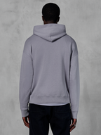 Sweat à capuche Alpinestars Essentials Ageless, molleton gris argenté, vue de dos, design pull minimaliste avec capuche et poignets côtelés, streetwear décontracté inspiré du sport automobile