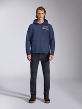 Alpinestars Formulation Hoodie, Navy Blue zip-up fleece hoodie, worn by male model with dark blue jeans, featuring red and white chest logo, mesh-lined hood with drawcords, casual motorsport streetwear