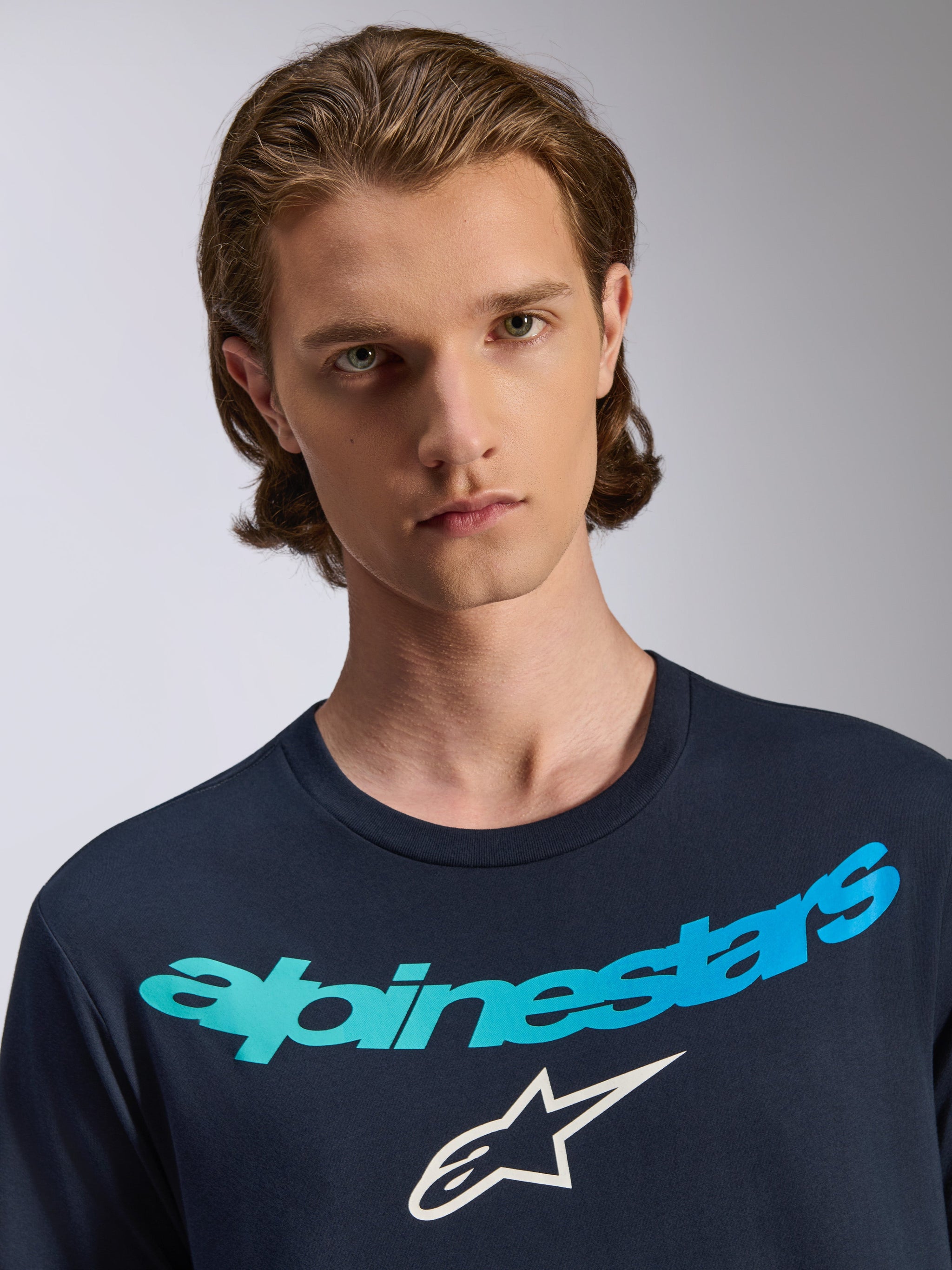 Alpinestars Collared CSF Tee, Short Sleeve T-Shirt, Navy Blue, featuring a blue and teal gradient Alpinestars logo and white star emblem, casual performance sportswear worn by a male model