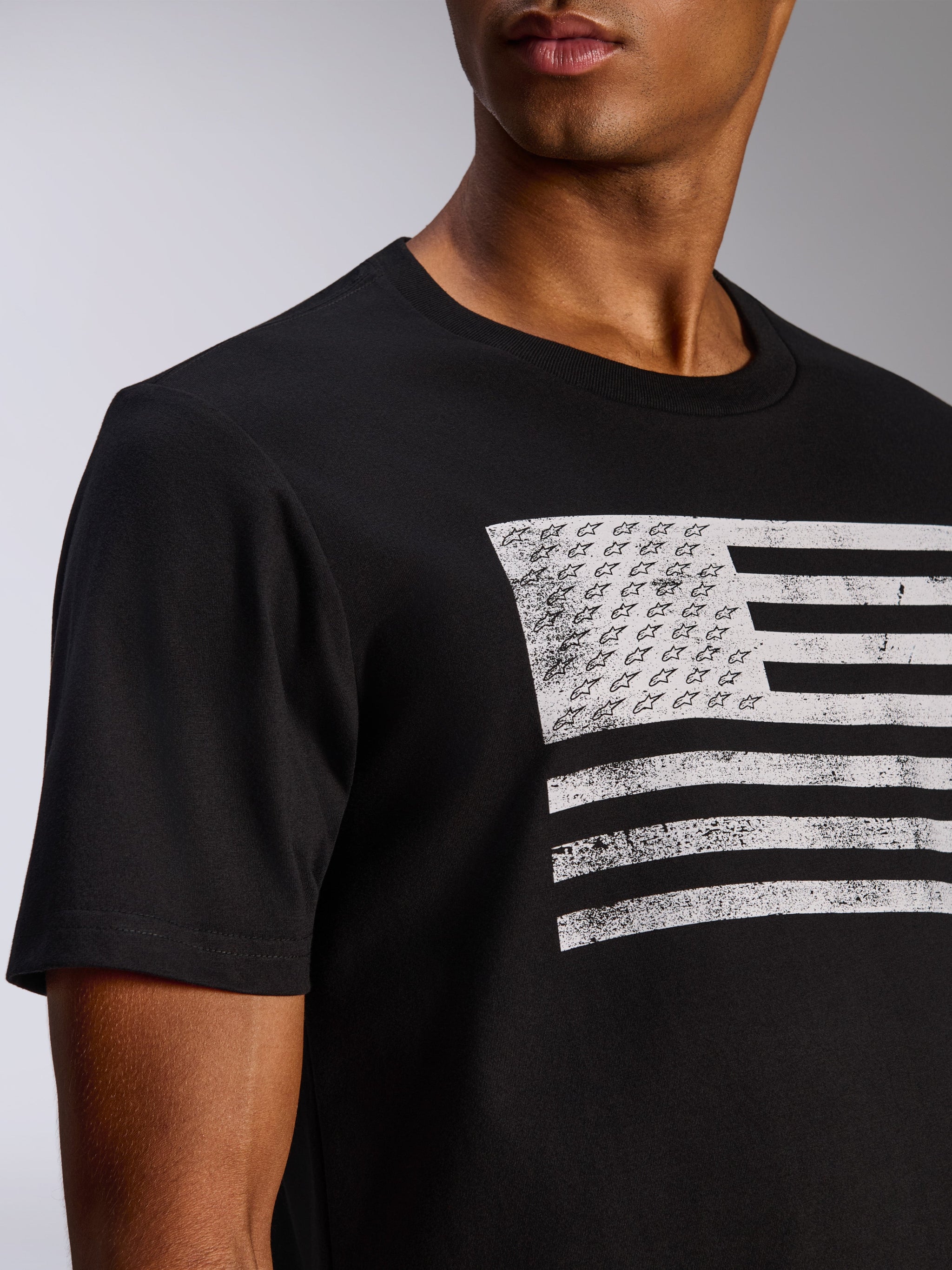 Alpinestars Waving CSF Tee, Short Sleeve T-Shirt, Black, Distressed White Flag Graphic with Alpinestars Stars and Stripes, Casual Motorsport Sportswear