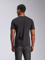 Alpinestars Tech Boot CSF Tee, Short Sleeve T-Shirt, Black, back view of a man wearing the tee with dark grey jeans, casual motorsport streetwear
